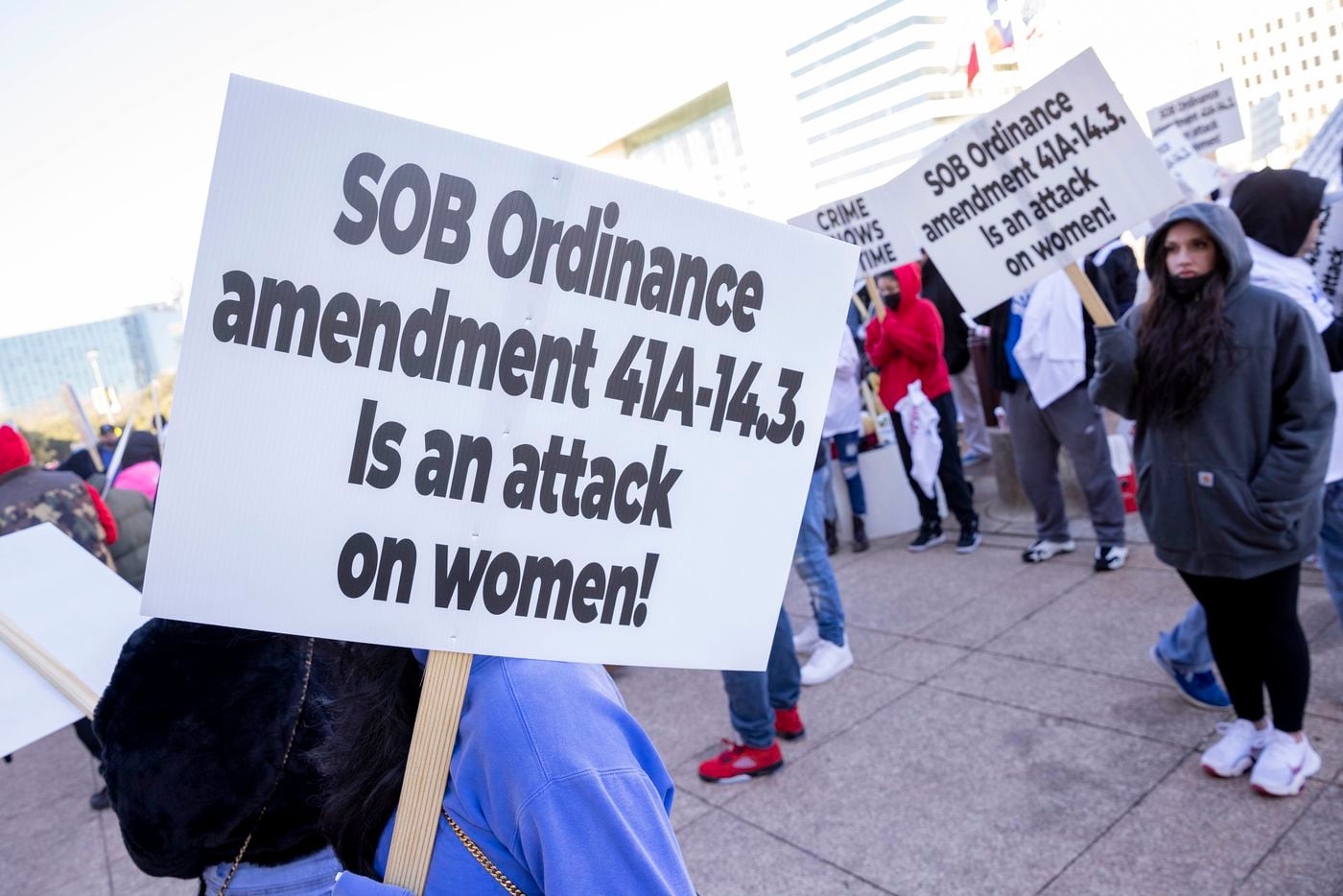 People protest the proposed sexually orientated business ordinance stand outside of City...