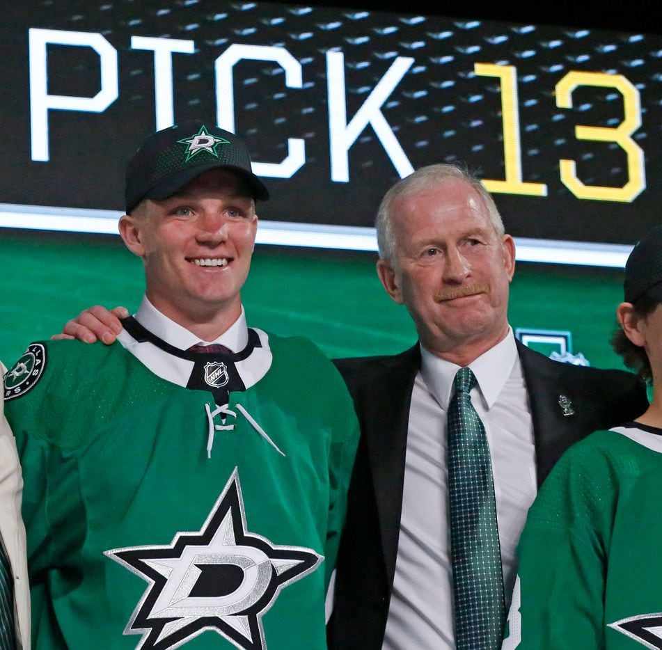 Dallas Stars first round draft pick Ty Dellandrea stands with General Manager Jim Nill at...