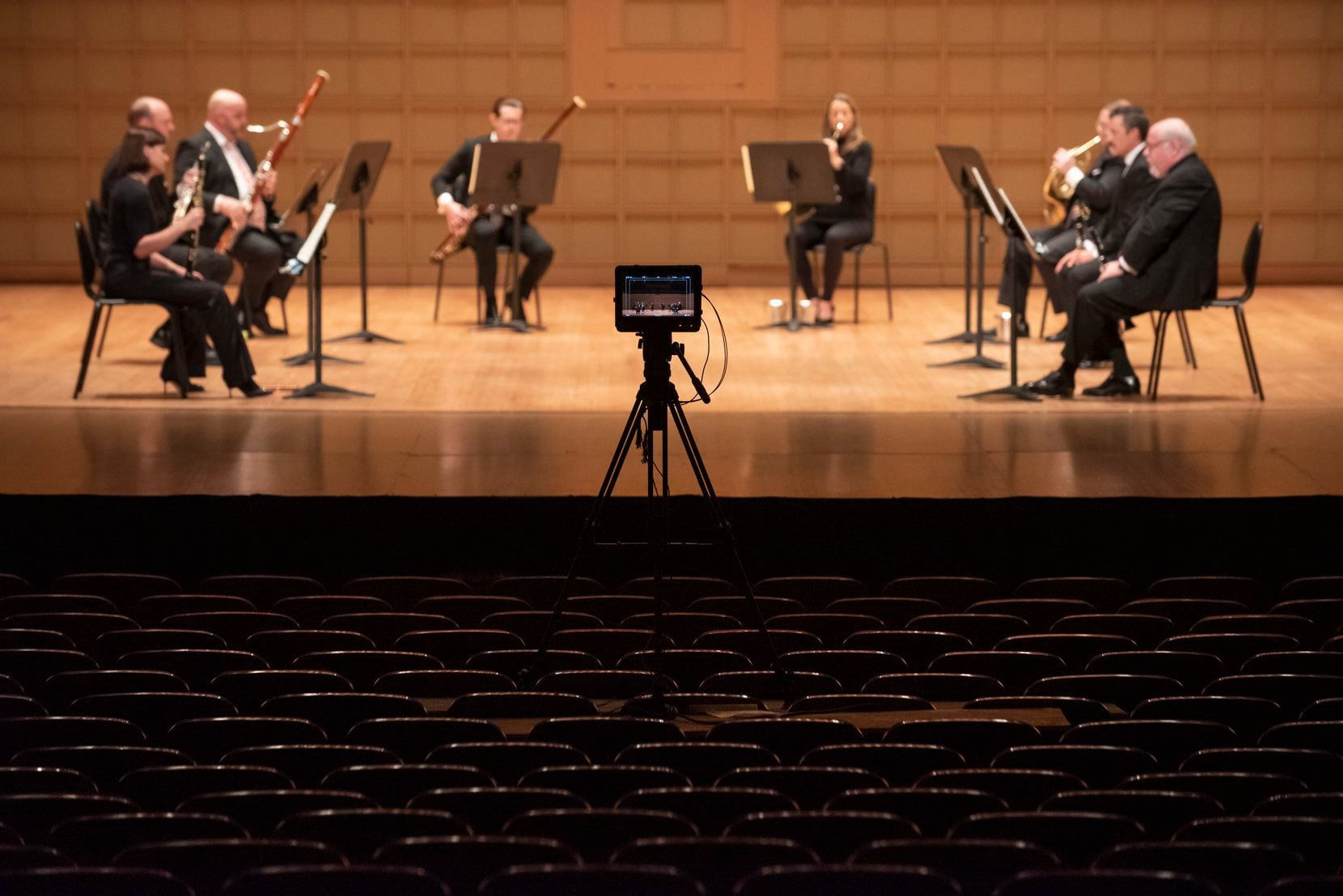An unmanned video camera records a performance by members of the Dallas Symphony Orchestra....