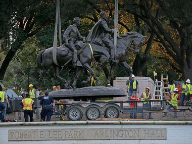 The Robert E. Lee statue is put in the back of a trailer truck at Robert E. Lee Park in...
