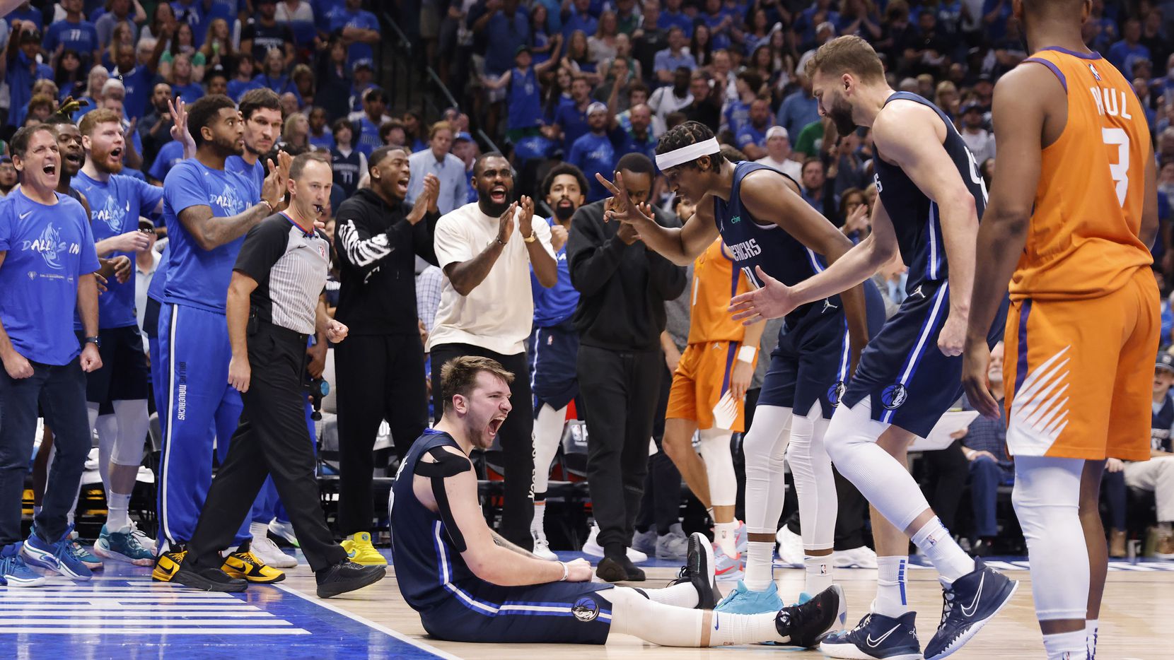 Dallas Mavericks guard Luka Doncic (77) and the rest of the bench react after he was fouled...