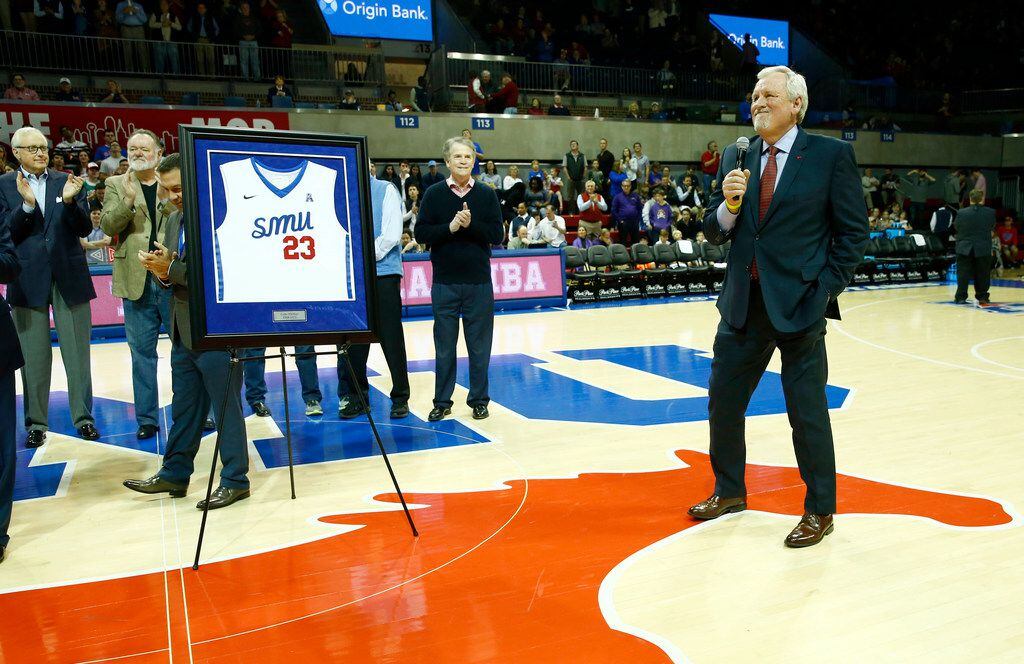 Gene Phillips celebrates having his number honored Moody Coliseum in Dallas on Jan. 28,...