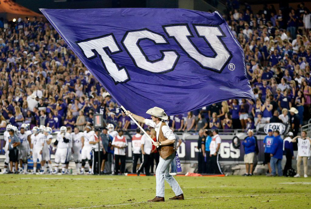 The TCU flag is waved on the field after a first half touchdown against the Kansas Jayhawks...