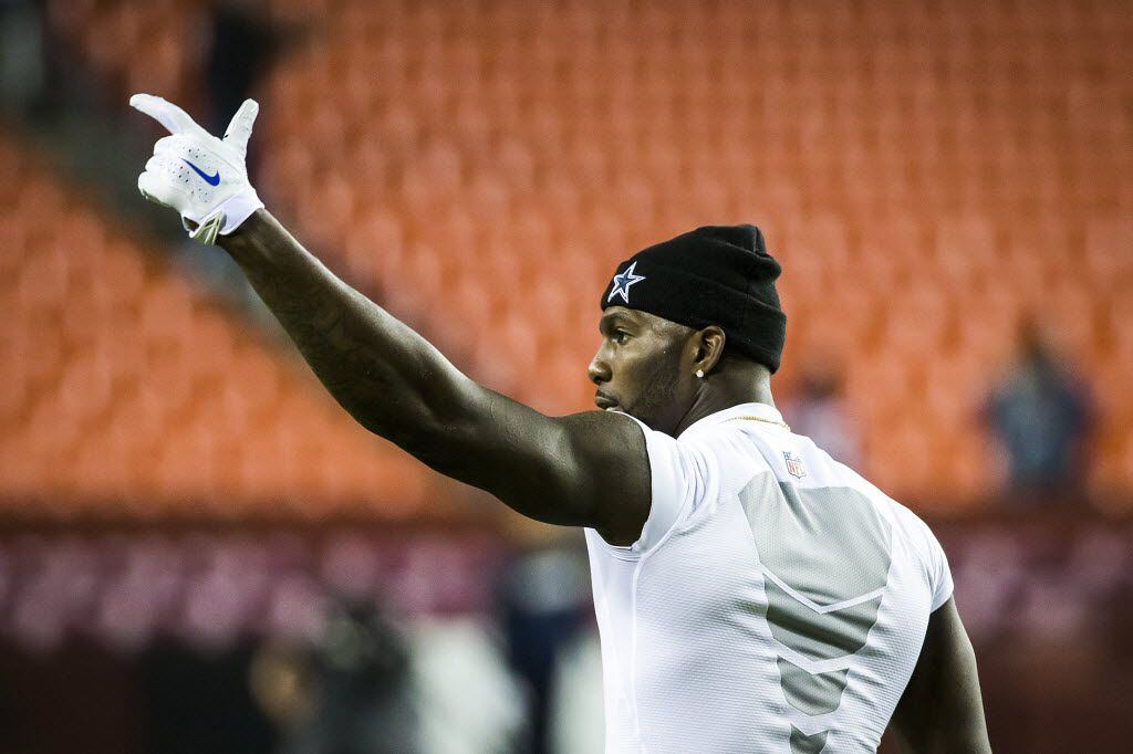 Dallas Cowboys wide receiver Dez Bryant acknowledges cheers from fans as he warms up before...
