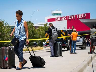 Passengers are directed away from the terminal at Dallas Love Field Airport on Monday, July...