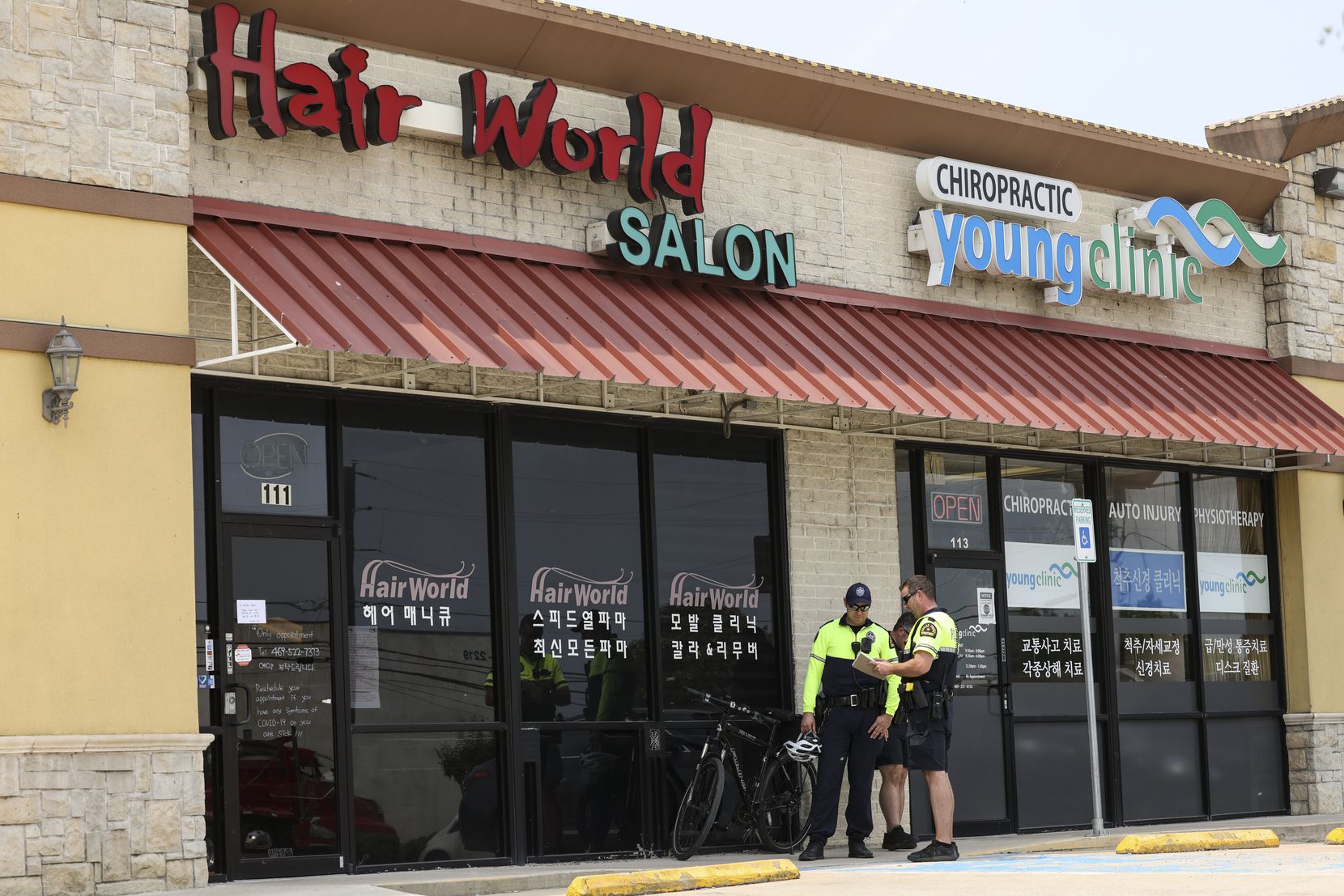 Police stand outside Hair World Salon on Tuesday, May 17, 2022 in Dallas, Texas. Dallas...