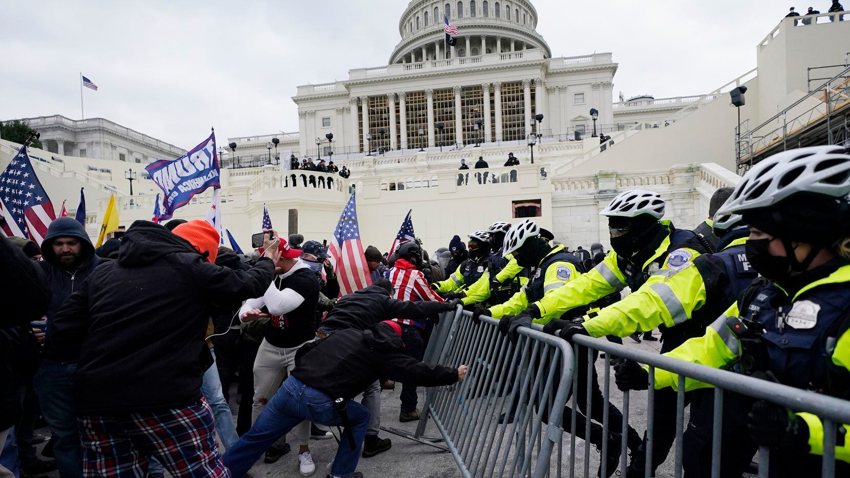 Insurrectionists loyal to President Donald Trump tried to break through a police barrier on...