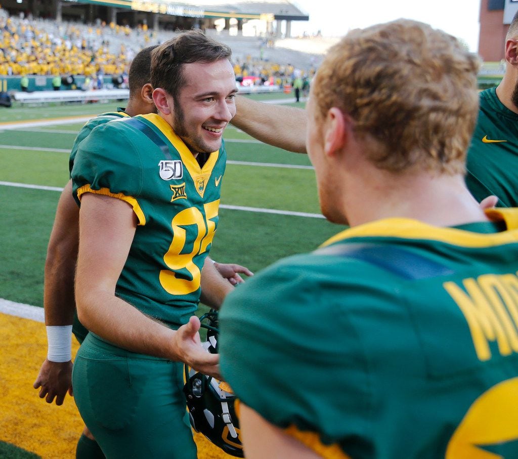 Baylor Bears place kicker John Mayers (95) is congratulated by Baylor Bears wide receiver Russell Morrison (83) after the school song played at McLane Stadium in Waco, Texas on Saturday, September 28, 2019. Baylor Bears defeated Iowa State Cyclones 23-21 with a game winning field goal from Mayers. (Vernon Bryant/The Dallas Morning News)