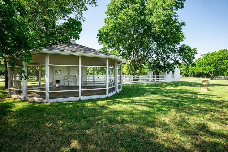 The property includes horse pastures, a chicken coop and polo field.
