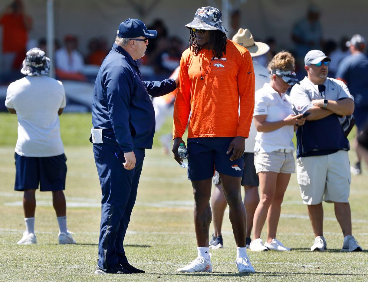 Former Cowboy and current Denver Broncos linebacker Randy Gregory (right) visits with Dallas...