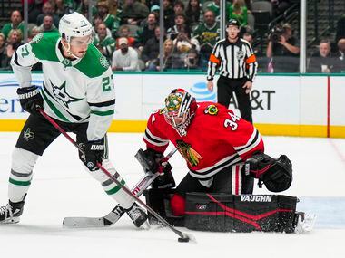 Dallas Stars left wing Mason Marchment (27) is turned away by Chicago Blackhawks goaltender...