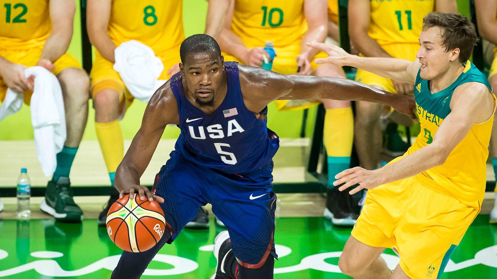 Kevin Durant (5) of the United States drives the ball around Ryan Broekhoff (9) of Australia...