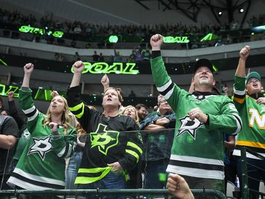 Dallas Stars fans cheer a goal by left wing Jason Robertson during the first period of an...
