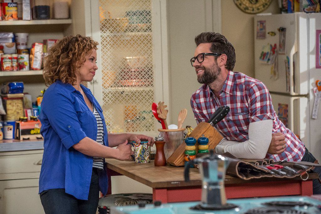 This image released by Netflix shows Justina Machado, left, and Todd Grinnell in a scene...