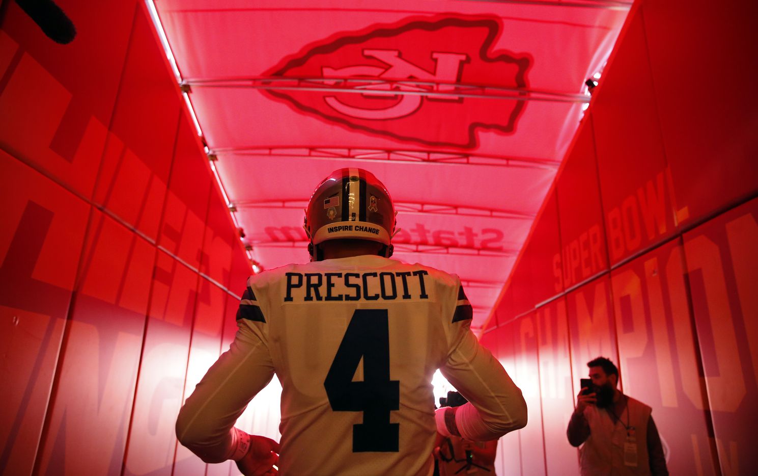 Dallas Cowboys quarterback Dak Prescott (4) walks to the field for pregame warmups before...