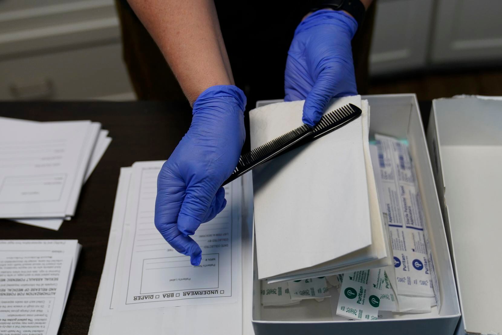 A Sexual Assault Evidence Collection Kit, or Rape Kit, is unpacked in an examination room,...