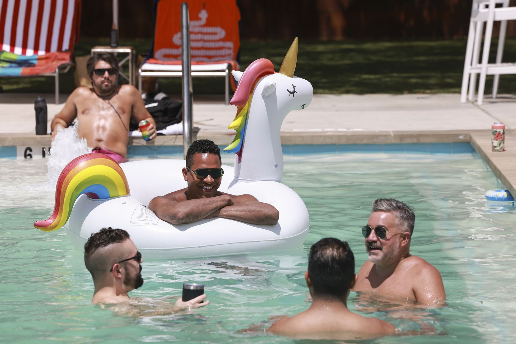 Moe MacDougall, 31, floats on a unicorn inflatable at Lee Harvey’s Dive In swimming pool. 
