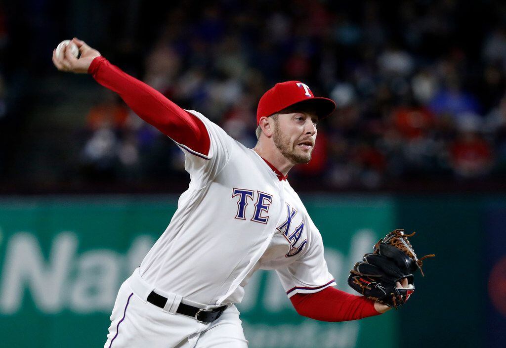 Texas Rangers relief pitcher Adrian Sampson throws to the Houston Astros in the fourth...