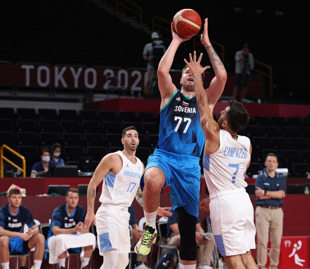 Slovenia’s Luka Doncic (77) attempts a shot in front of Argentina’s Facundo Campazzo (7) in the first half of play during the postponed 2020 Tokyo Olympics at Saitama Super Arena on Monday, July 26, 2021, in Saitama, Japan. Slovenia defeated Argentina 118-100. (Vernon Bryant/The Dallas Morning News)
