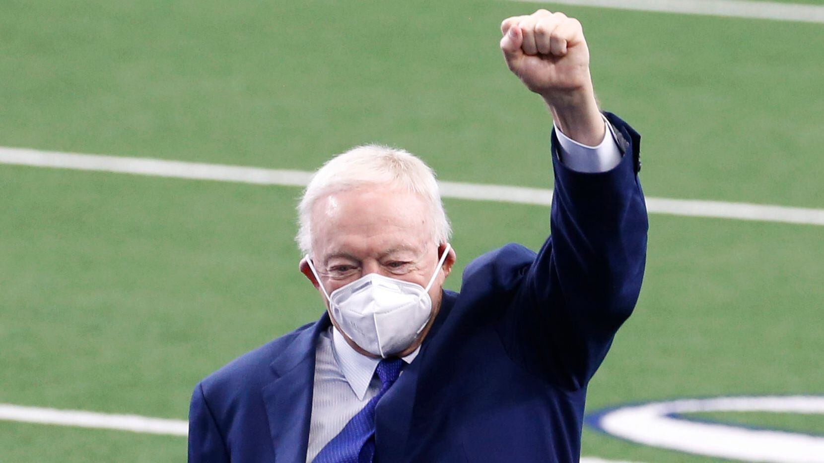 Dallas Cowboys owner and general manager Jerry Jones puts his fist in the air as he exits...