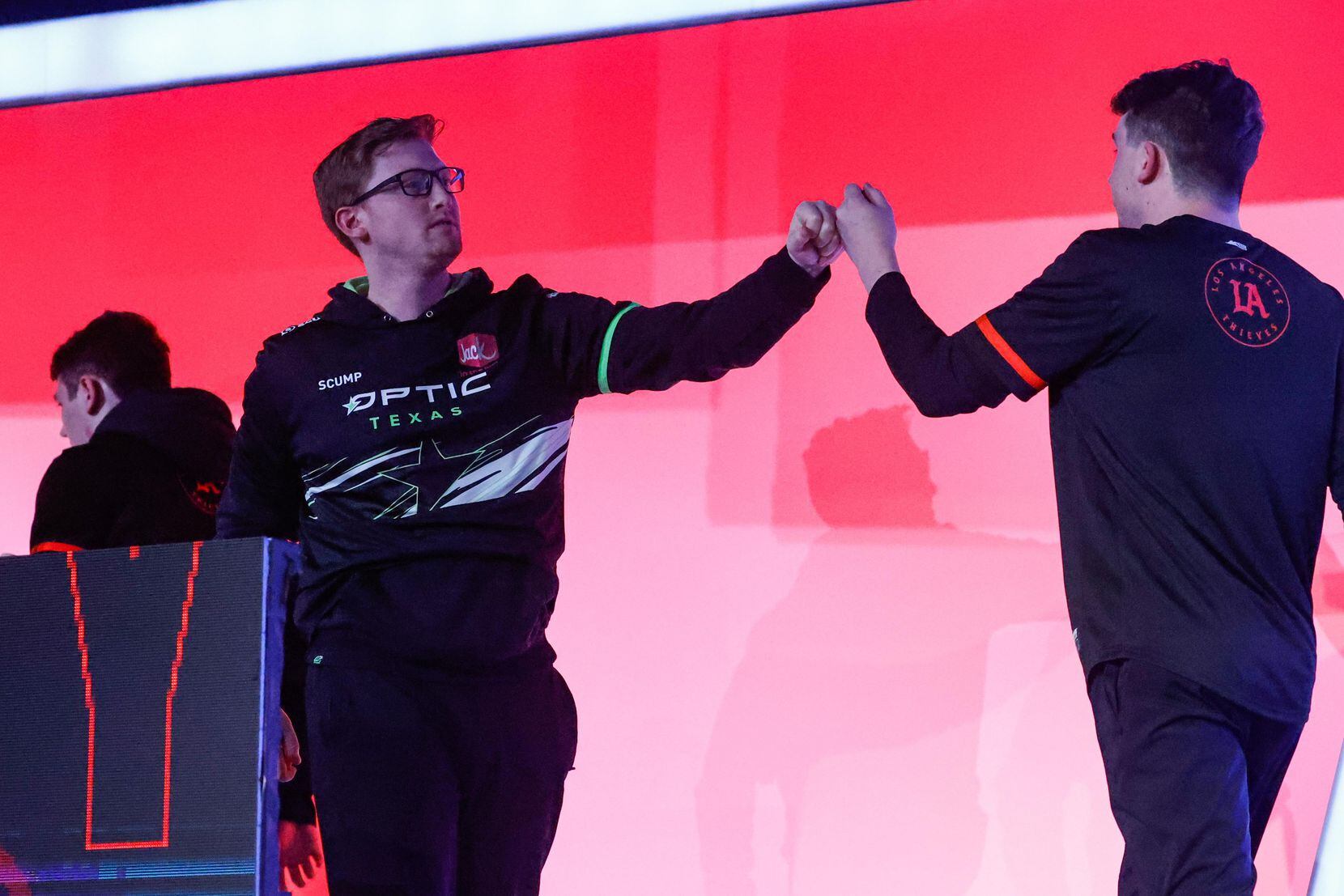 OpTic Texas' Seth "Scump" Abner (left) fist bump one of the Los Angeles Thieves player after...