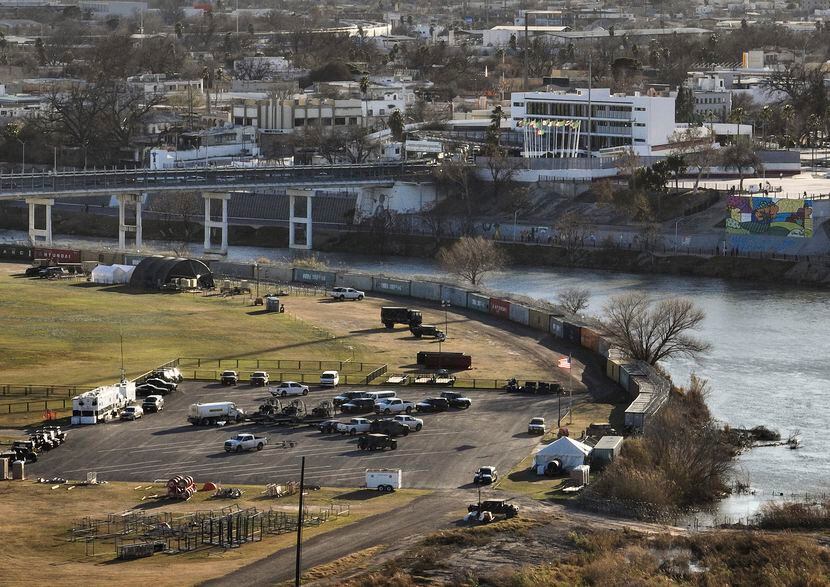 Shipping containers and concertina wire line the banks of the Rio Grande, in Shelby Park in...