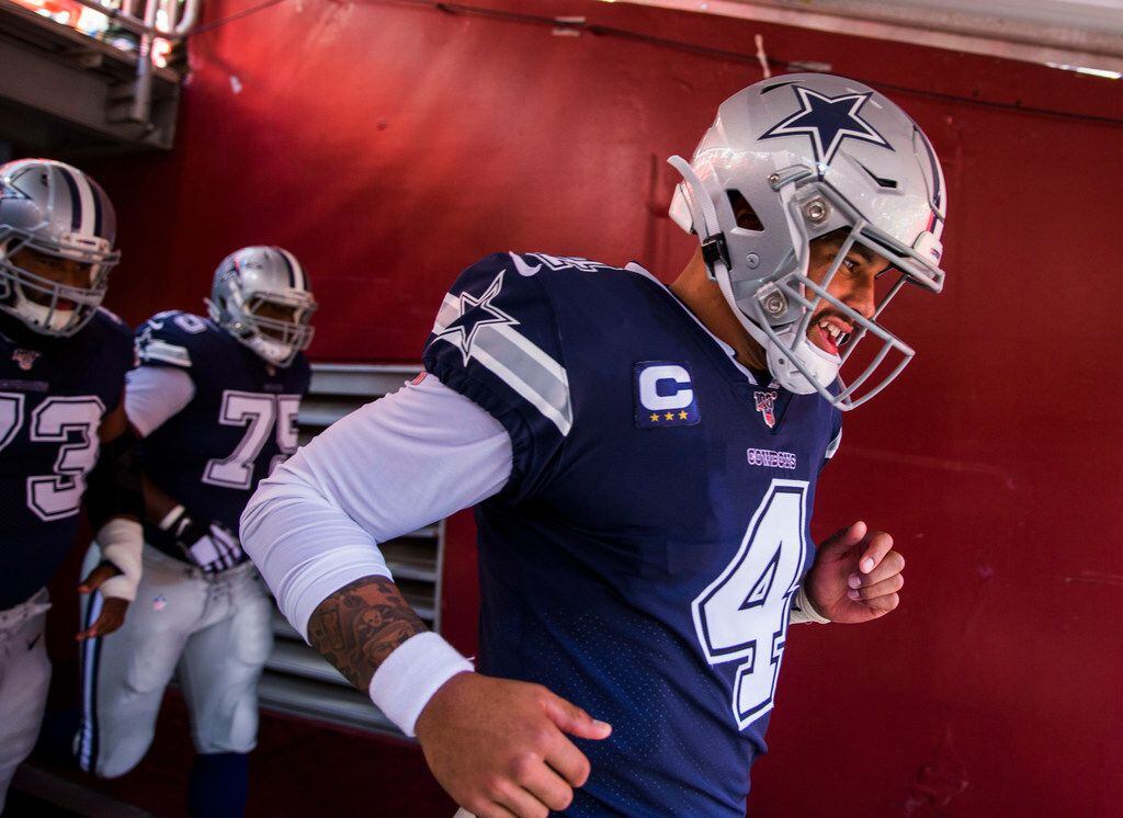 Dallas Cowboys quarterback Dak Prescott (4) runs through the tunnel before an NFL game...