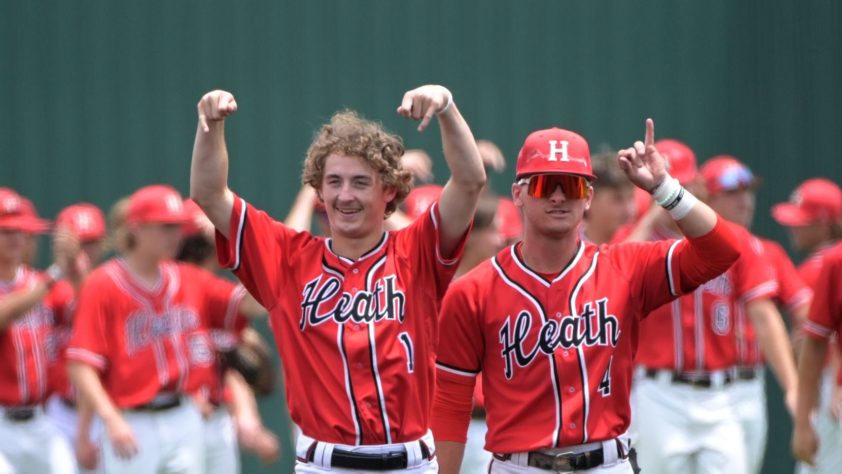 Rockwall Heath's Baylor Baumann (1) and Jett Williams (4) celebrate after their win of game...