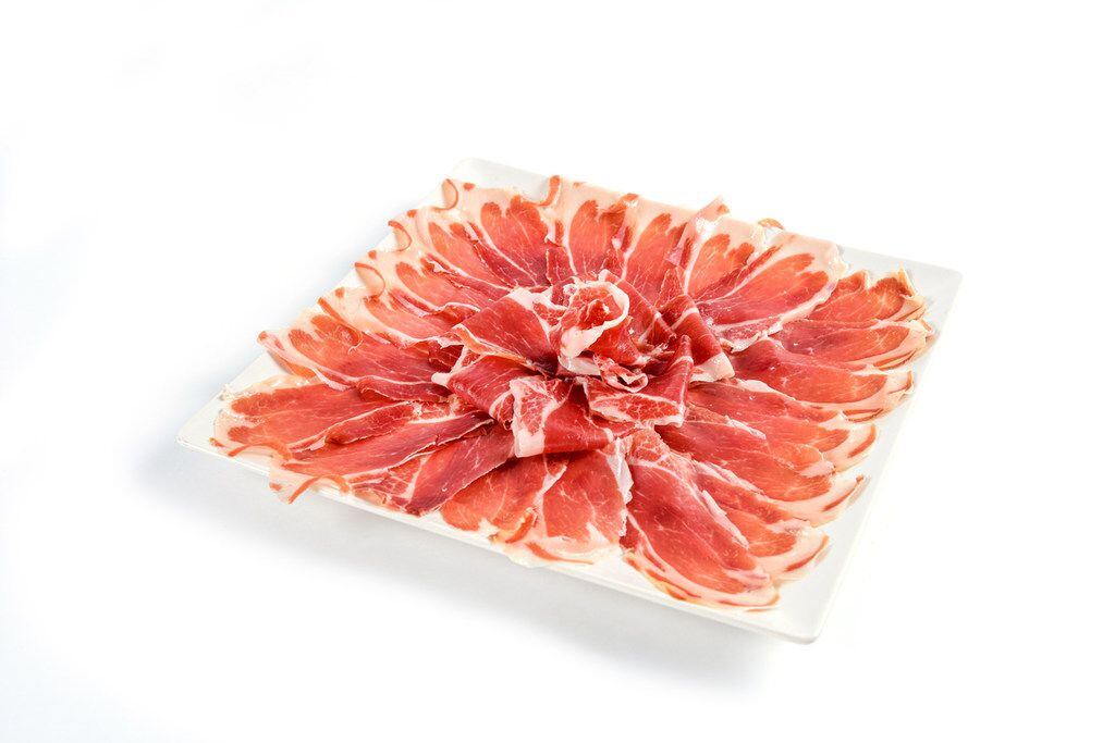 Jamón ibérico (Iberian ham) is the specialty at Enrique Tomás, a purveyor from Spain. A...