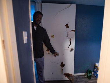 Deric Jones, 34, points at holes in his bedroom door that were never repaired before he...