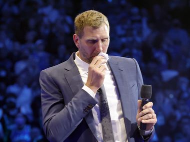 Former Dallas Mavericks All-Star Dirk Nowitzki and his family watch as his jersey is lifted from the floor as the team retired No. 41 at the American Airlines Center in Dallas, January 5, 2022.