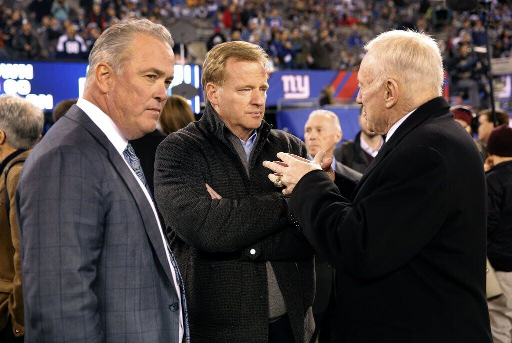 Dallas Cowboys owner Jerry Jones (left) visits with NFL Commissioner Roger Goodell (center)...