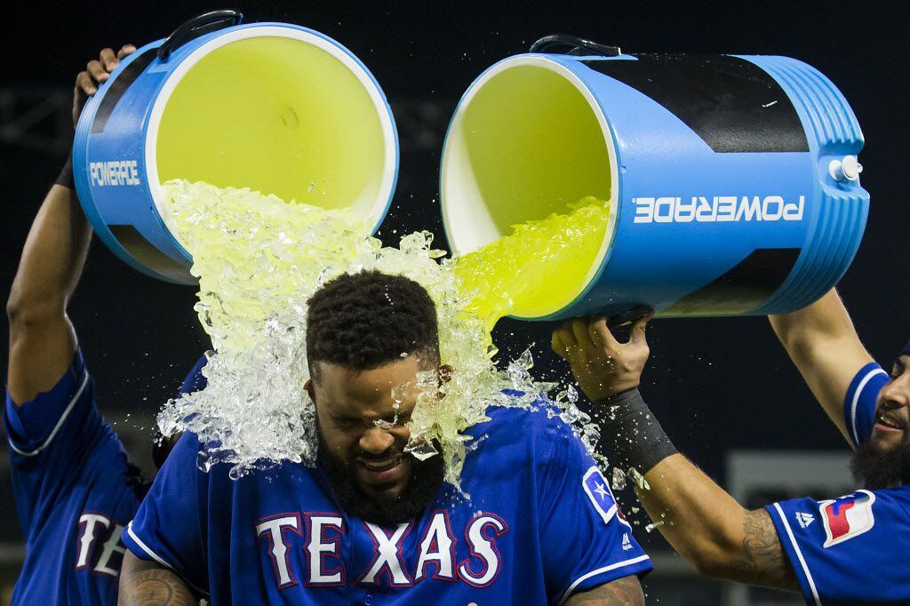 Texas Rangers designated hitter Prince Fielder is doused with Powerade and water by...