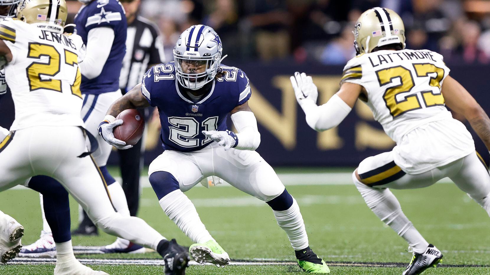 Dallas Cowboys running back Ezekiel Elliott (21) carries the ball as New Orleans Saints cornerback Marshon Lattimore (23) closes in during the first quarter at the Caesars Superdome in New Orleans, Louisiana December 2, 2021.