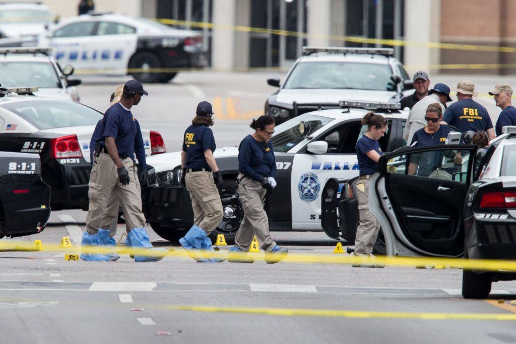 FBI investigators gathered evidence Saturday in downtown Dallas where a gunman opened fire on officers, killing five and wounding several others.