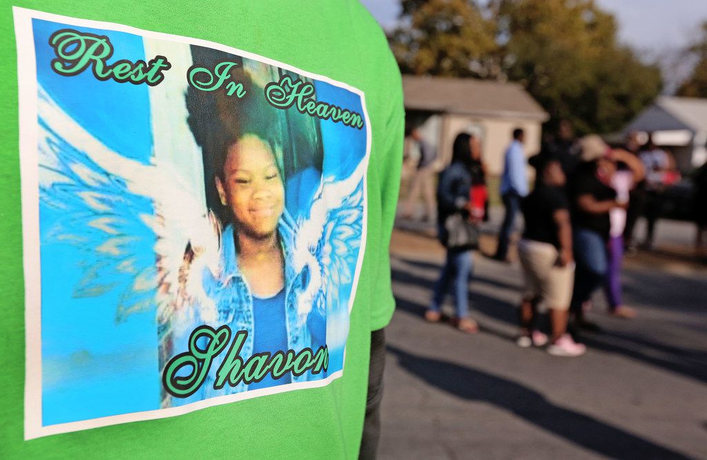 Many attendees of the demolition of the structure at 2208 E. Kiest Blvd. in Oak Cliff south of Dallas, where the body of 13-year-old Shavon Randle was found in July 2017, wore shirts honoring her.