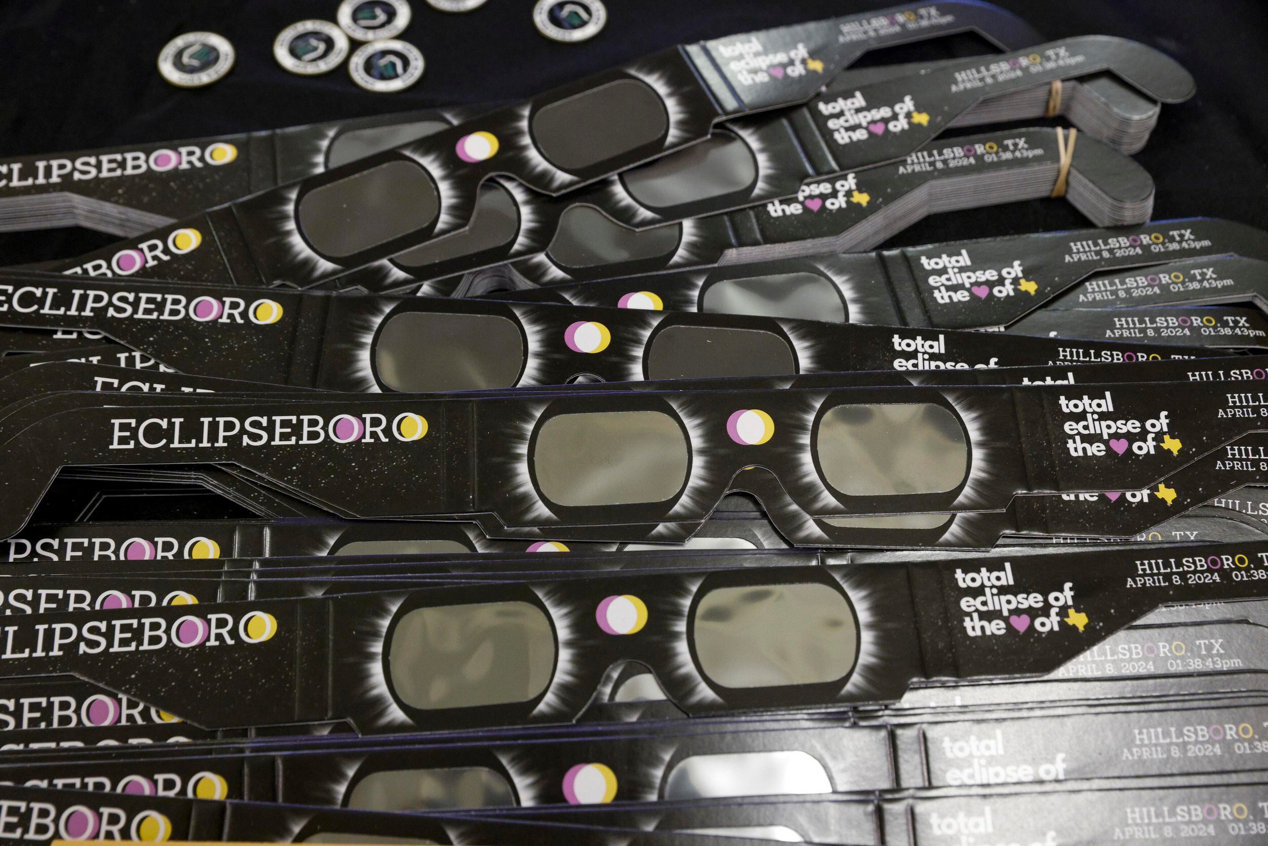 “Eclipseboro” branded eclipse viewing glasses are seen before a town hall meeting, Tuesday,...