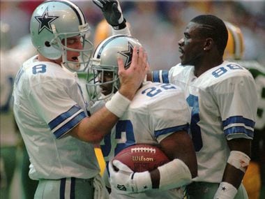 Dallas Cowboys Troy Aikman (8), Emmitt Smith (22) and Michael Irvin (88) celebrate Smith's second-quarter touchdown run in the NFC Championship game against the Green Bay Packers in Irving, Texas, in this January 14, 1996 photo.