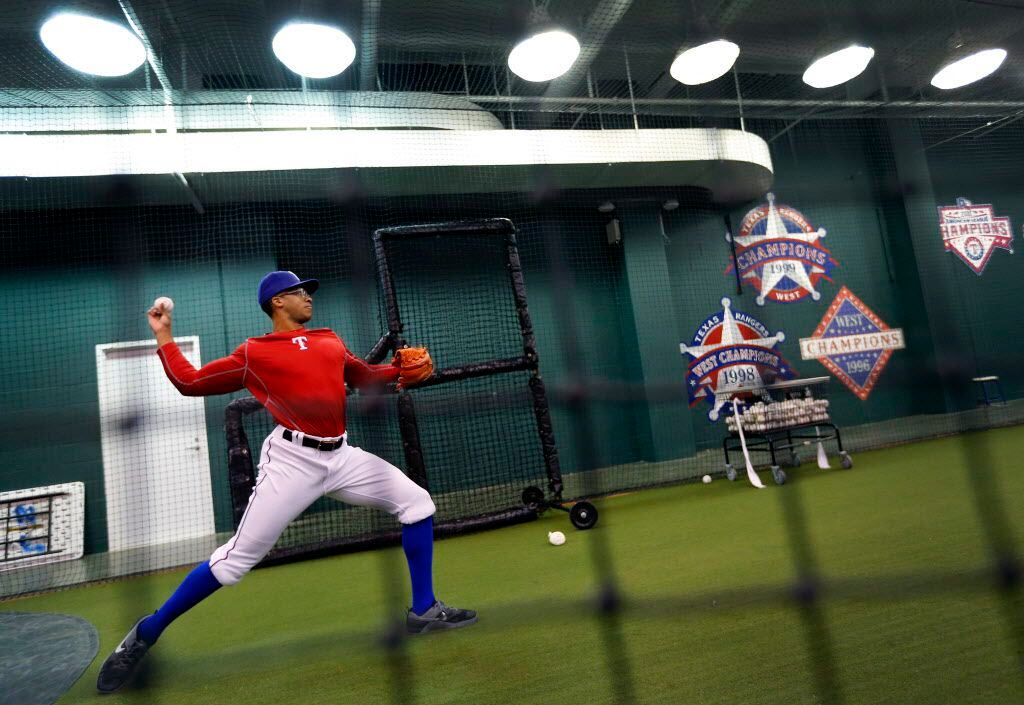 Pitcher Dillon Tate throws in their indoor workout area  of Globe Life Park in Arlington...