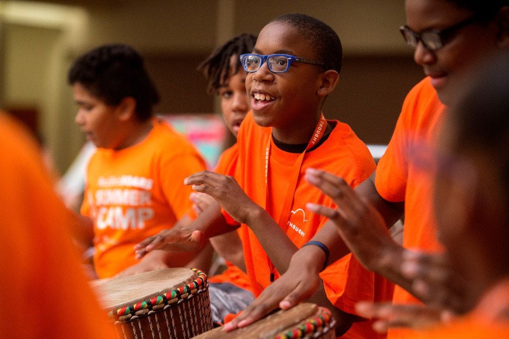 Campers play African drum during the Red Bird SOARS summer camp.