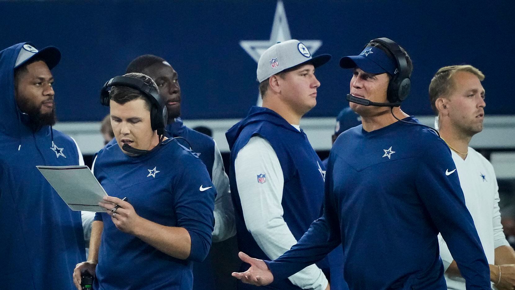 Dallas Cowboys offensive coordinator Kellen Moore (left) works on the sidelines during the...