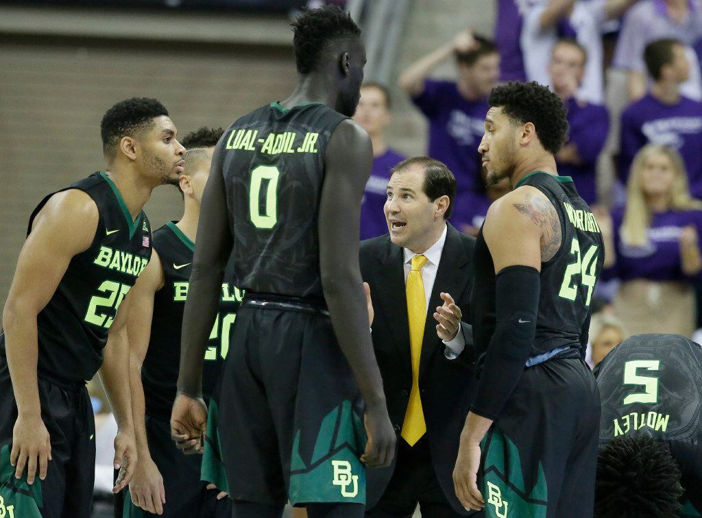 Baylor head coach Scott Drew, second from right, gives directions to his players during the...
