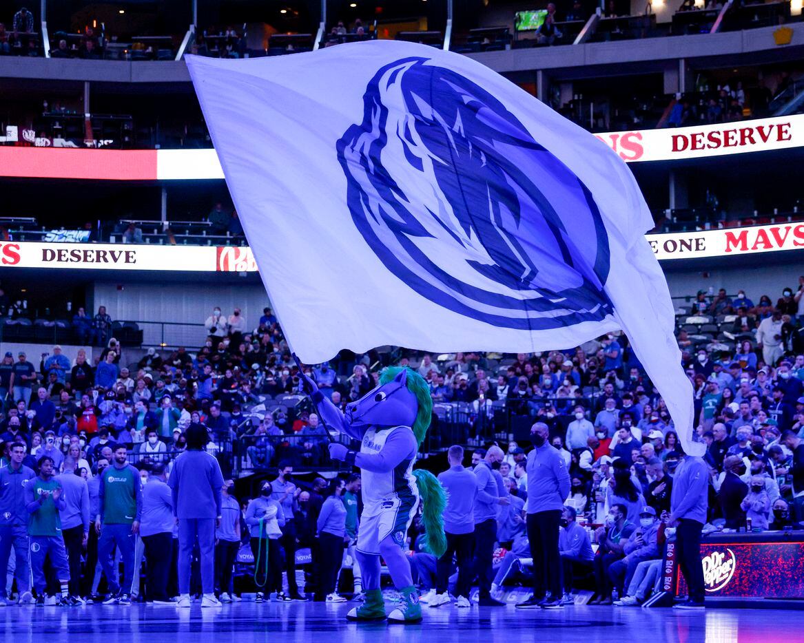 Champ waves a Dallas Mavericks flag before player introductions during a game against the...