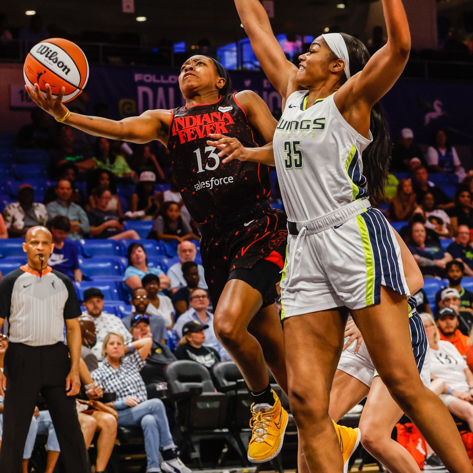 Indiana Fever Kayla Pointer (13) goes for a shot as Dallas Wings forward Charli Collier (35)...
