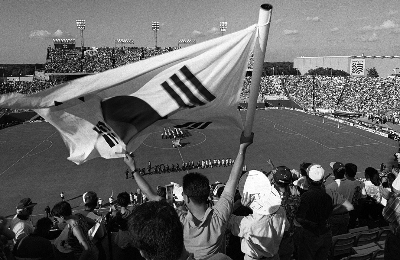 A fan waves a South Korean  flag before the start of the first World Cup game in Dallas...