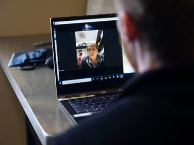 Almost all large companies have health plans that cover video chats between patients and providers, and the virtual offers are expanding next year. In this March photo, Dr. Ryan Klitgaard (right) speaks with a patient during a telemedicine visit at his clinic in Colleyville.