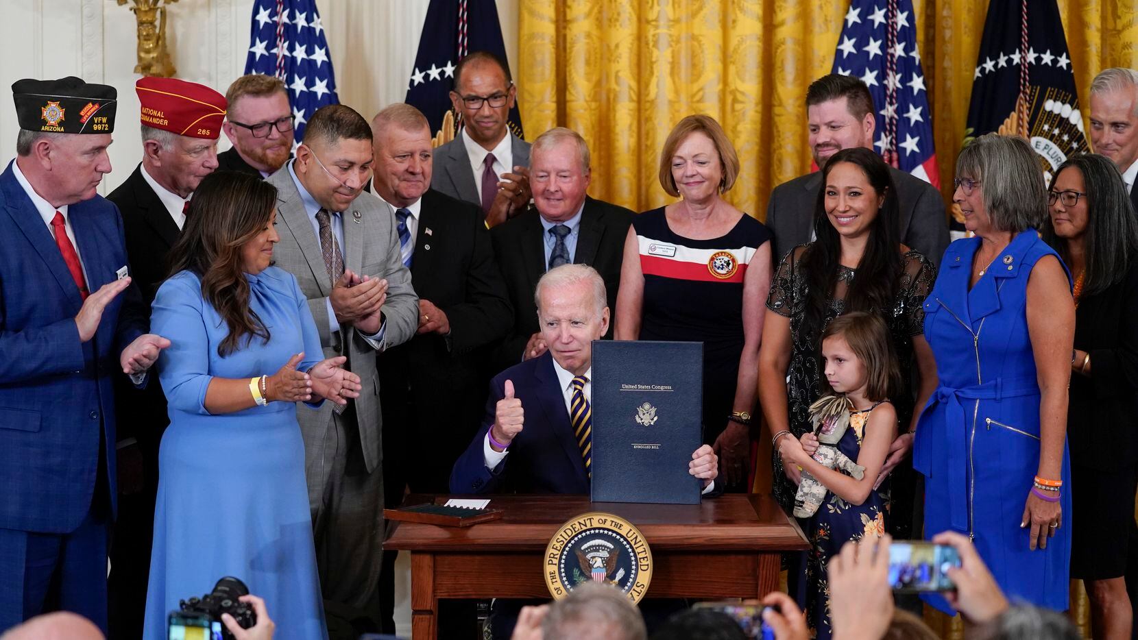 President Joe Biden held the "PACT Act of 2022" after signing it during a ceremony in the...