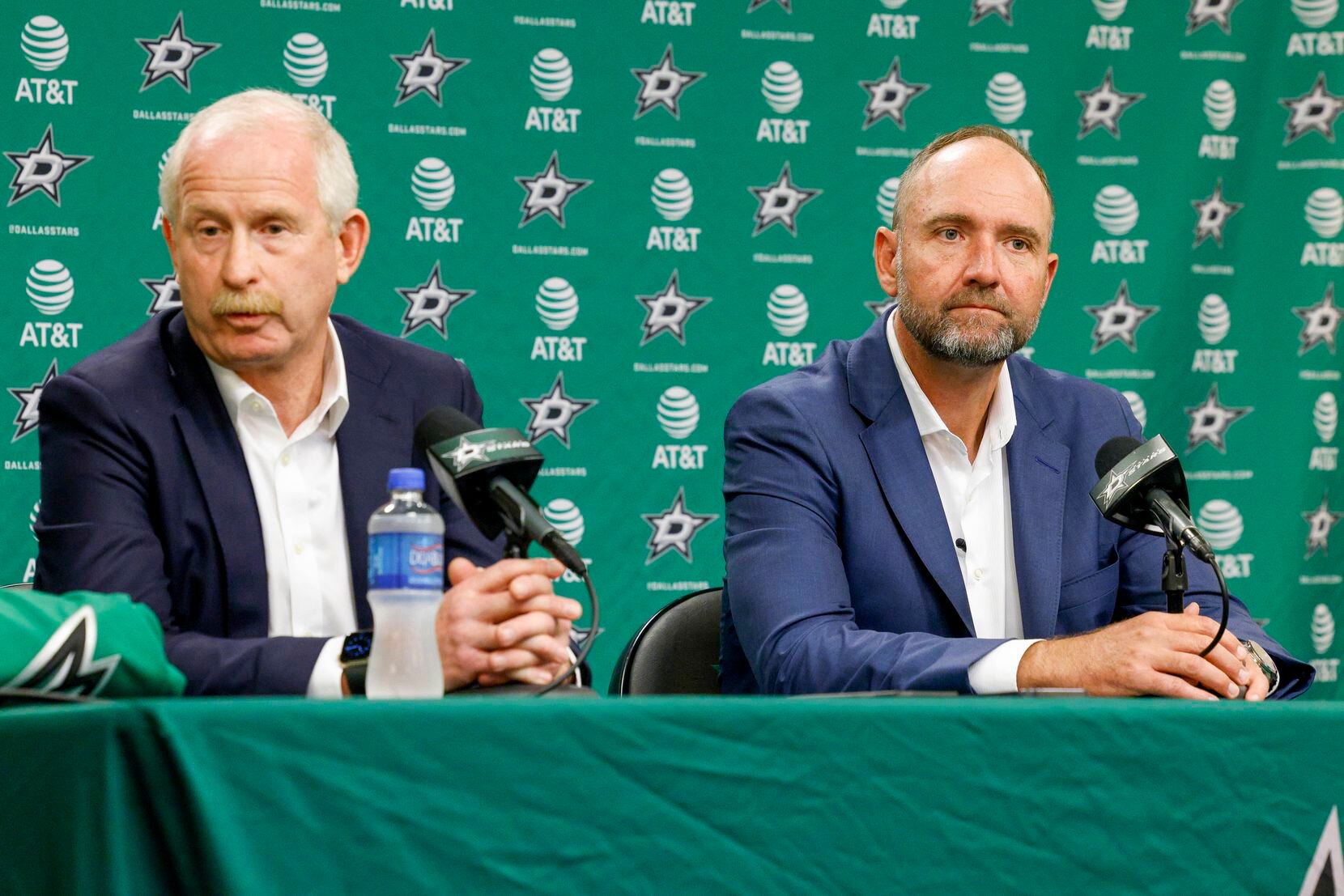 Jim Nill, Dallas Stars general manager (left), answers a question from a reporter alongside...
