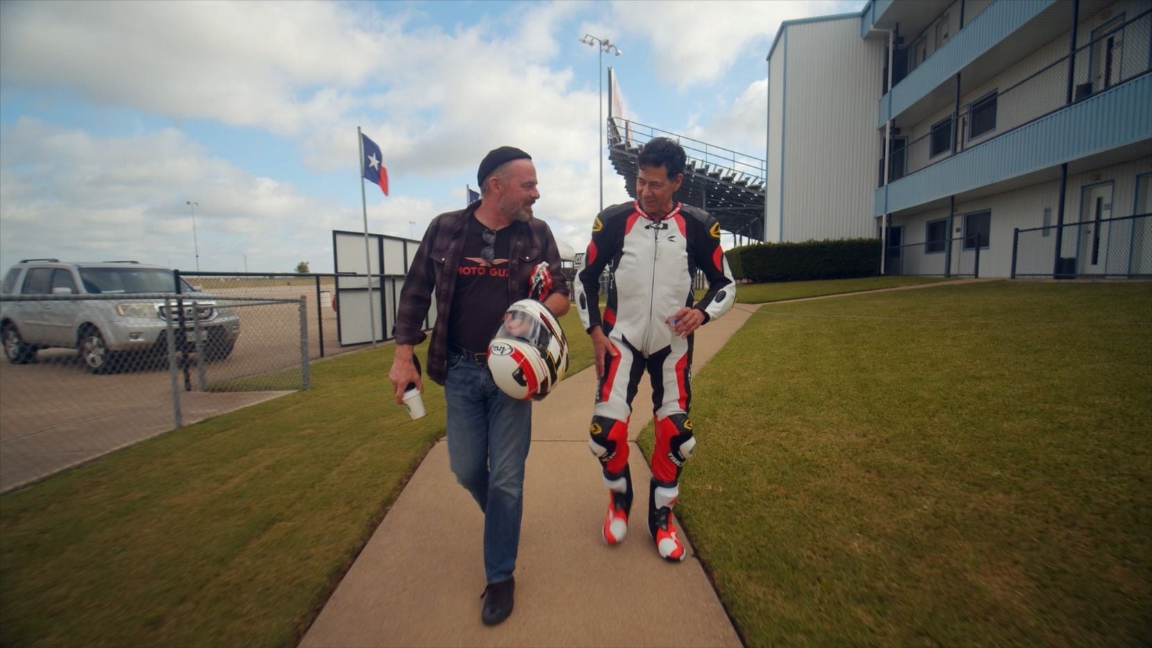 Custom motorcycle builder Craig Rodsmith walks with Bobby Haas before a sidecar test run at...