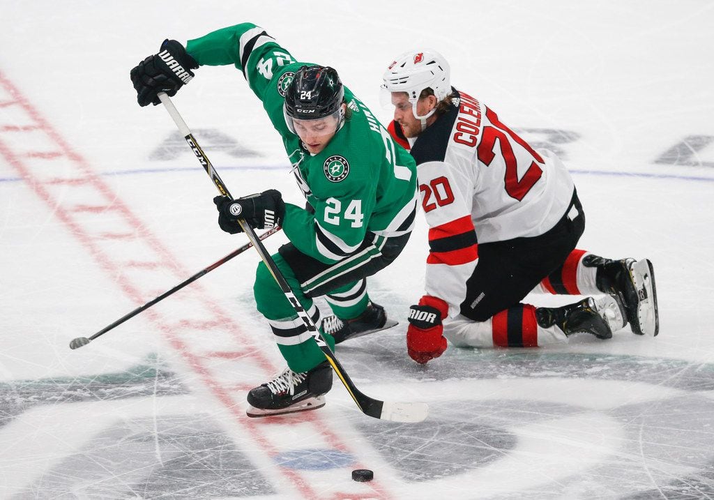 FILE - Stars left wing Roope Hintz (24) steals the puck from New Jersey Devils center Blake...